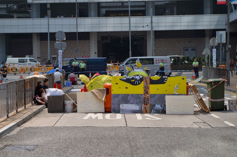 Barricades built from wood and garbage cans